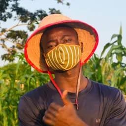 Tractor harvesting crops in Nigerian farmland